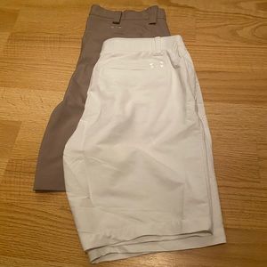 A bundle of khaki and white under armor shorts